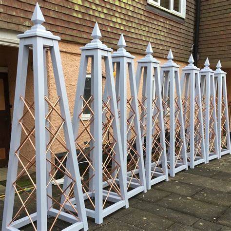 painted wooden obelisk trellis
